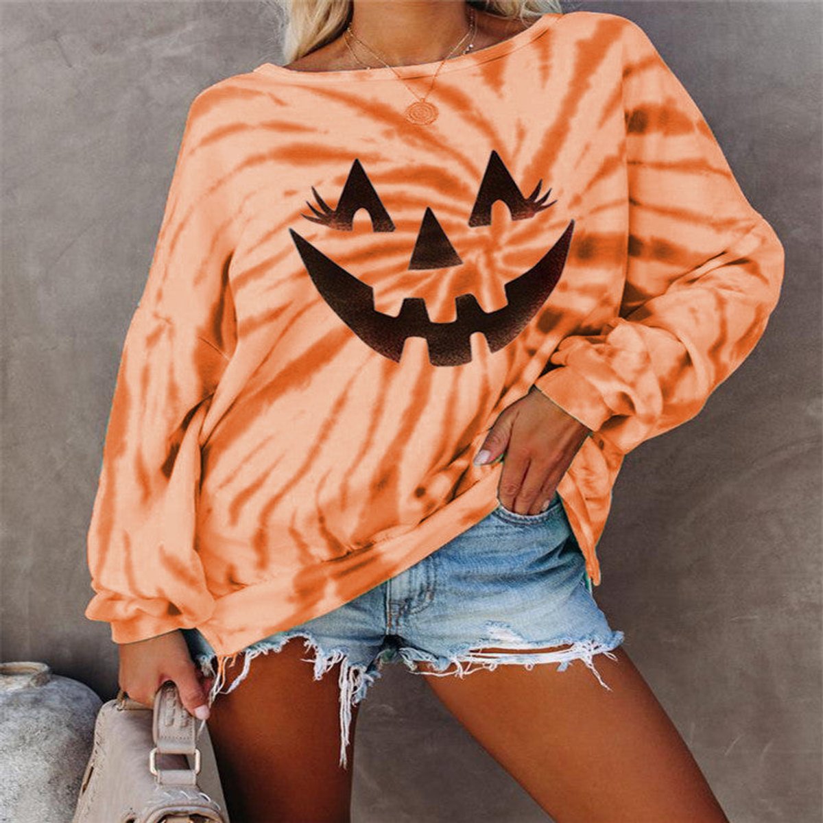 Tie-dye pumpkin face sweatshirt in orange for women